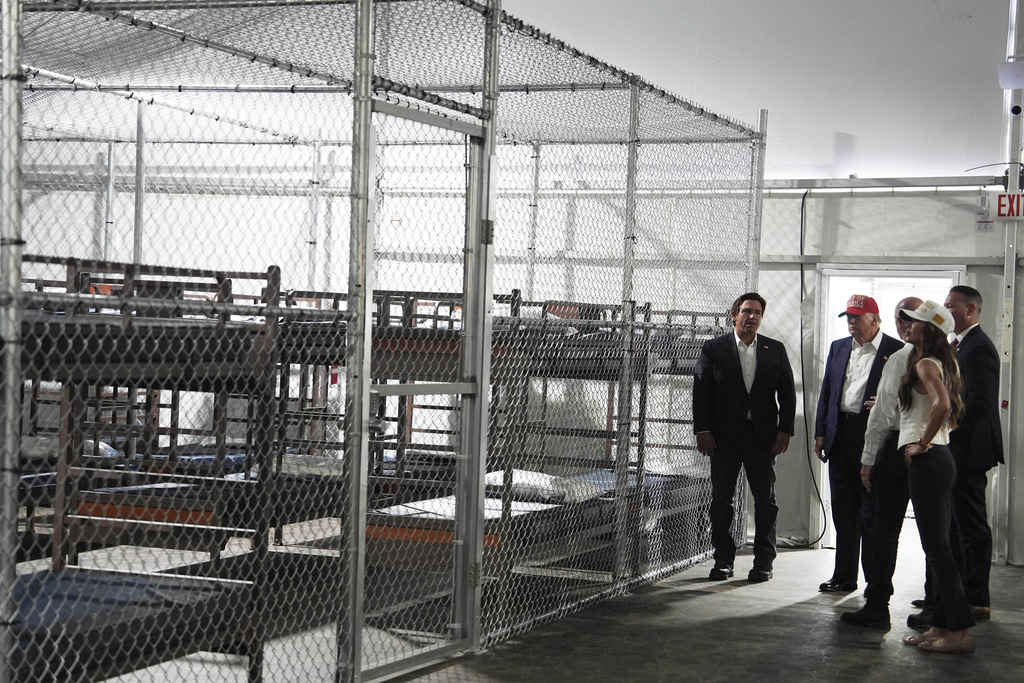 President Donald Trump, Gov. Ron DeSantis, R-Fla., and Homeland Security Secretary Kristi Noem, and others, tour "Alligator Alcatraz," a new migrant detention facility at Dade-Collier Training and Transition facility, Tuesday, July 1, 2025, in Ochopee, Fla. (AP Photo/Evan Vucci)