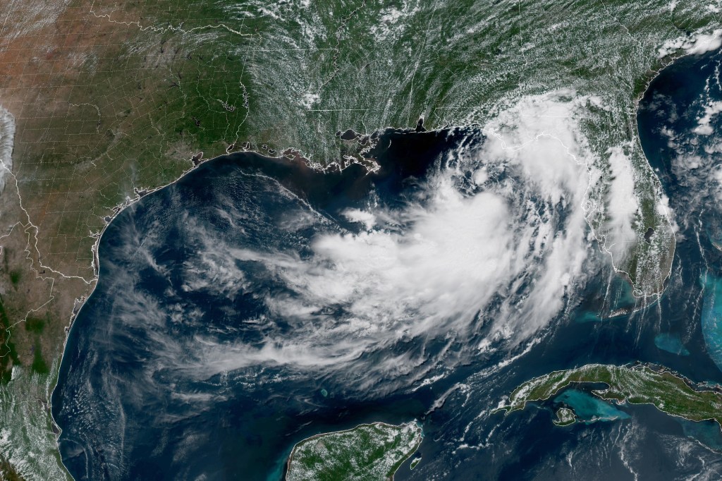 Satellite view of a tropical depression over the Gulf of Mexico, impacting the coastlines of Florida and the Yucatán Peninsula.