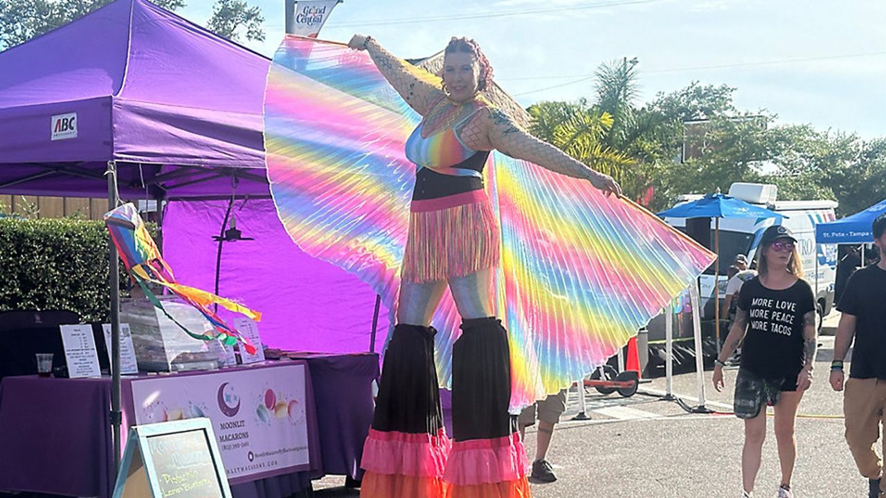 A woman dressed in rainbow colors walks on stilts during this year's St. Pete Pride street fair on May 29.