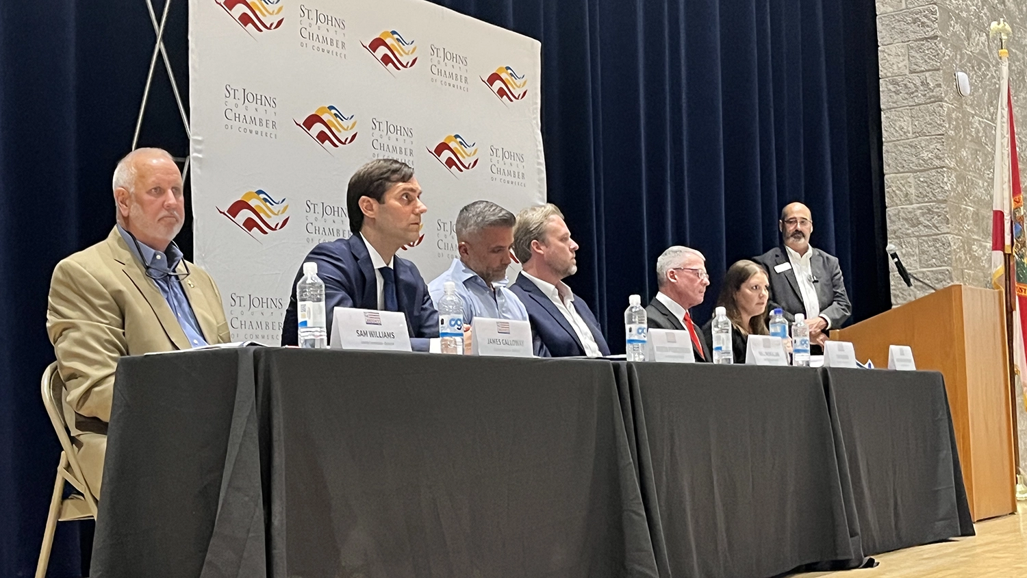 St. Johns County Commission candidates sit at a table during a candidate forum.