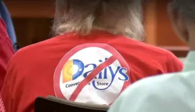 A resident wears a red shirt with a circle and slash through a Daily's logo.