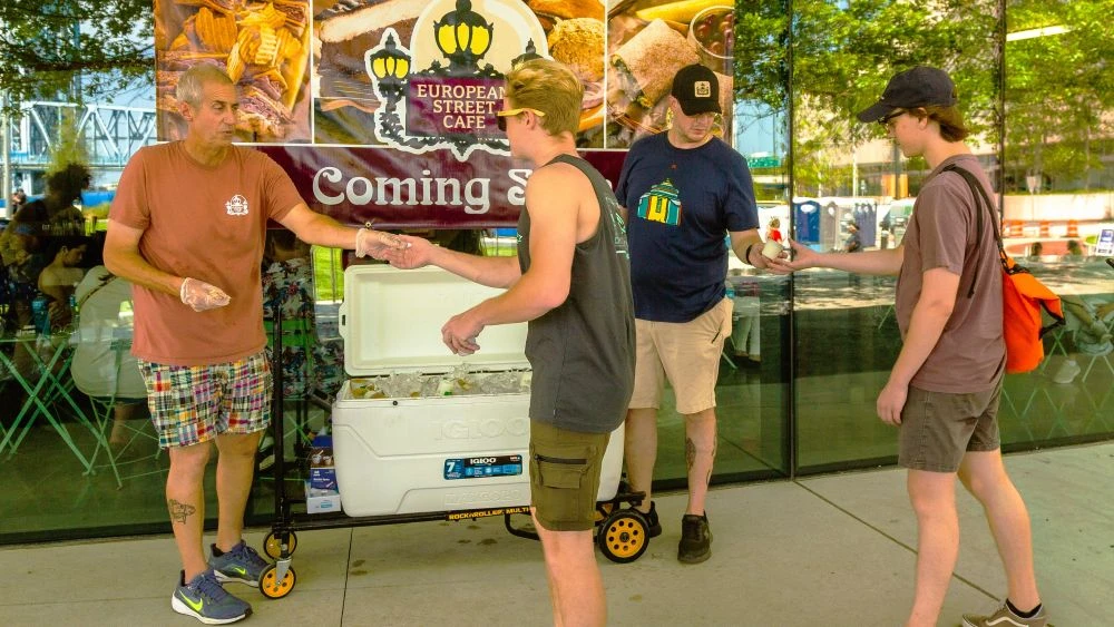 European Street Cafe owner Andy Zarka passing out snacks at a July 4th event at Riverfront Plaza.