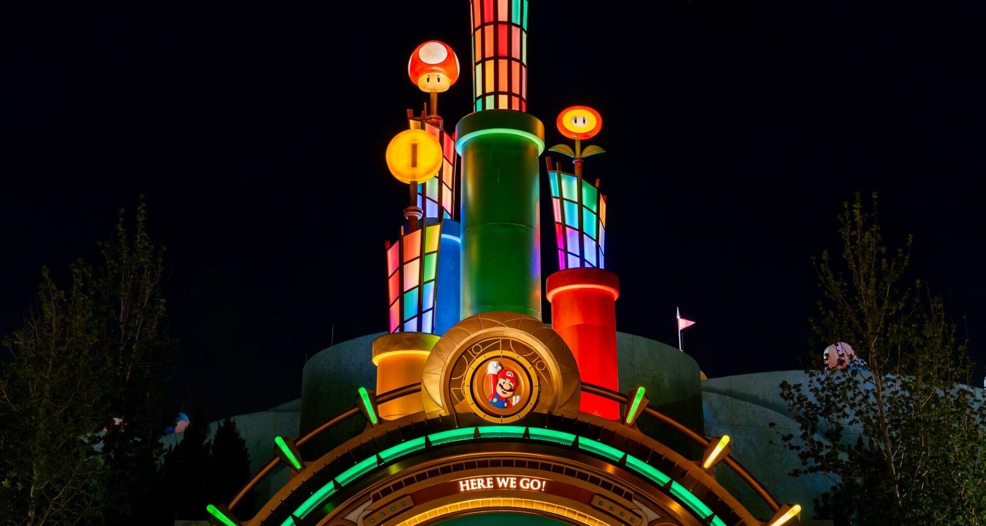 A colorful, illuminated Super Mario-themed entrance at Epic Universe, glowing with stars and coins for a perfect photo report.