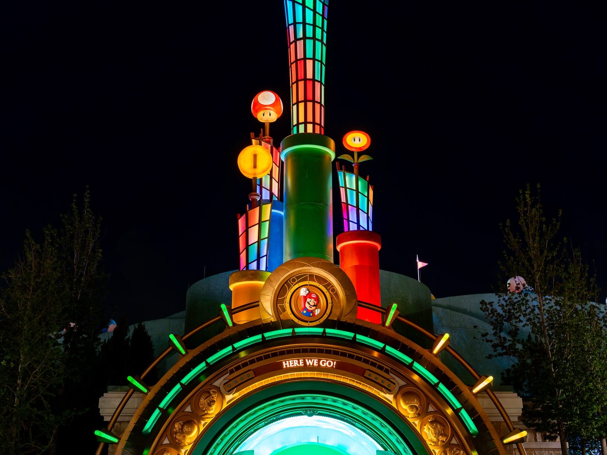 A colorful, illuminated Super Mario-themed entrance at Epic Universe, glowing with stars and coins for a perfect photo report.