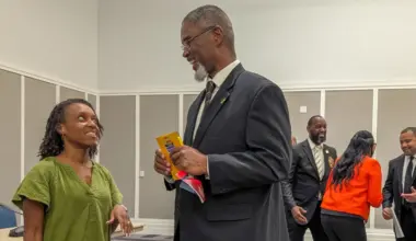 Marquita H. Green and Rhodesia "Rho" Butler speak with potential voters at an election forum sponsored by Alpha Phi Alpha Fraternity Inc.