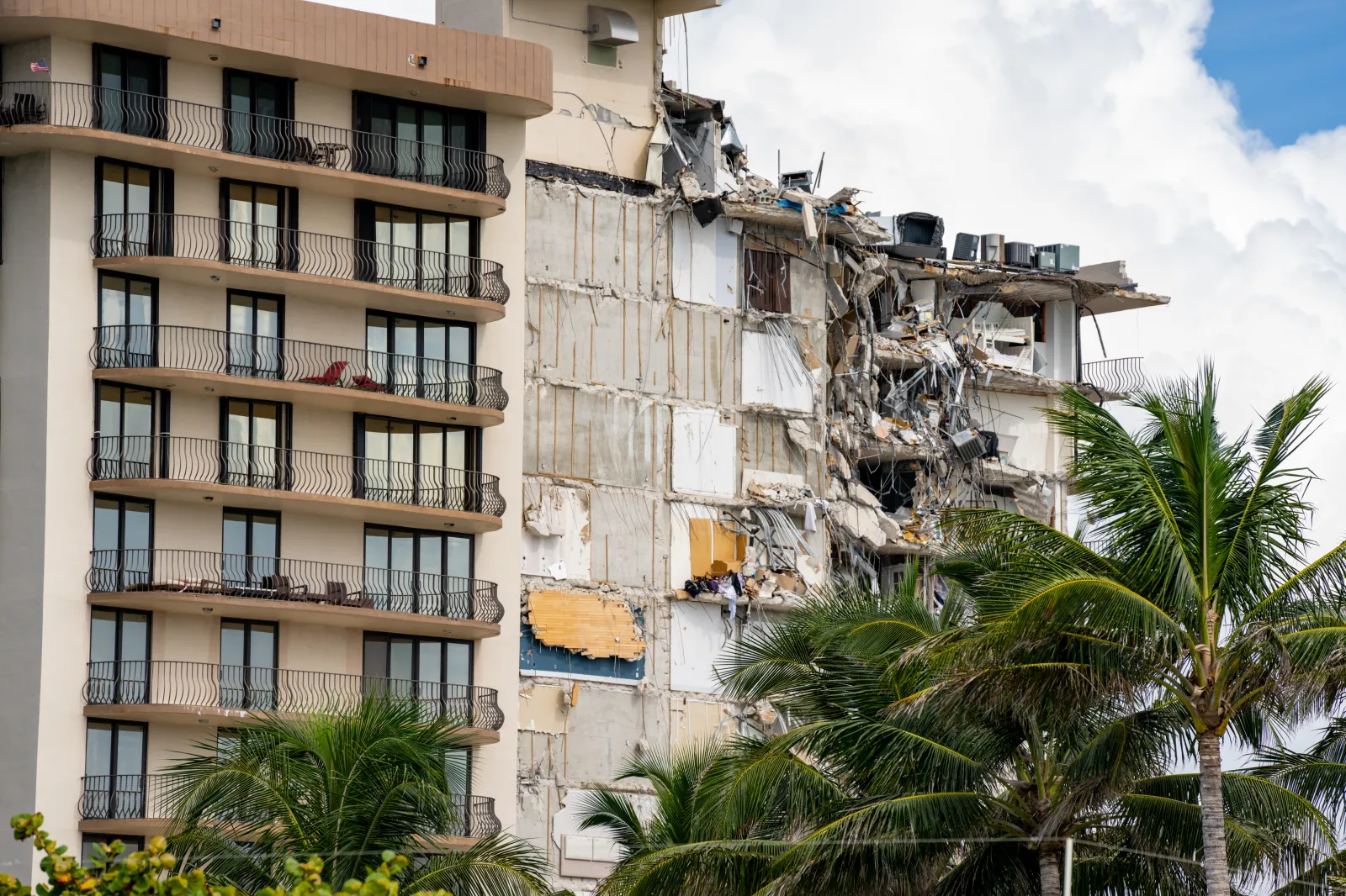 Miami Beach Surfside, FL, USA — June 26, 2021: Champlain Towers remains 2 days after collapse owners personal belongings visible hanging from the units