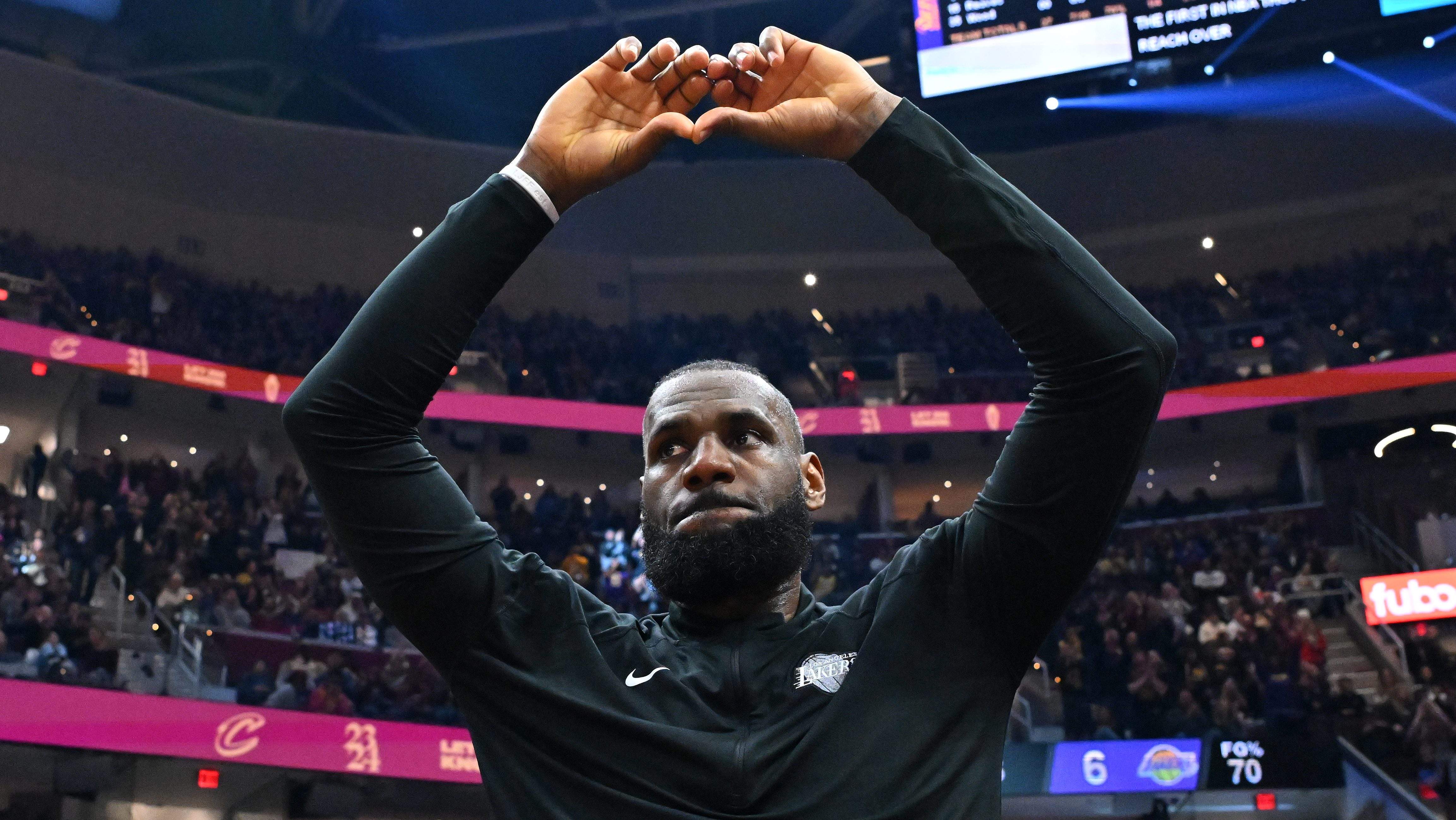 LeBron James forms a heart with his hands while acknowledging Cleveland Cavaliers fans before a game against the Los Angeles Lakers.