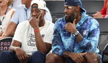 LeBron James sits with Miami Heat center Bam Adebayo during a Team USA basketball event.