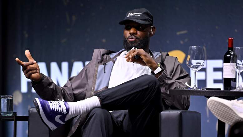 LeBron James gestures while speaking onstage with a microphone at Fanatics Fest in New York.
