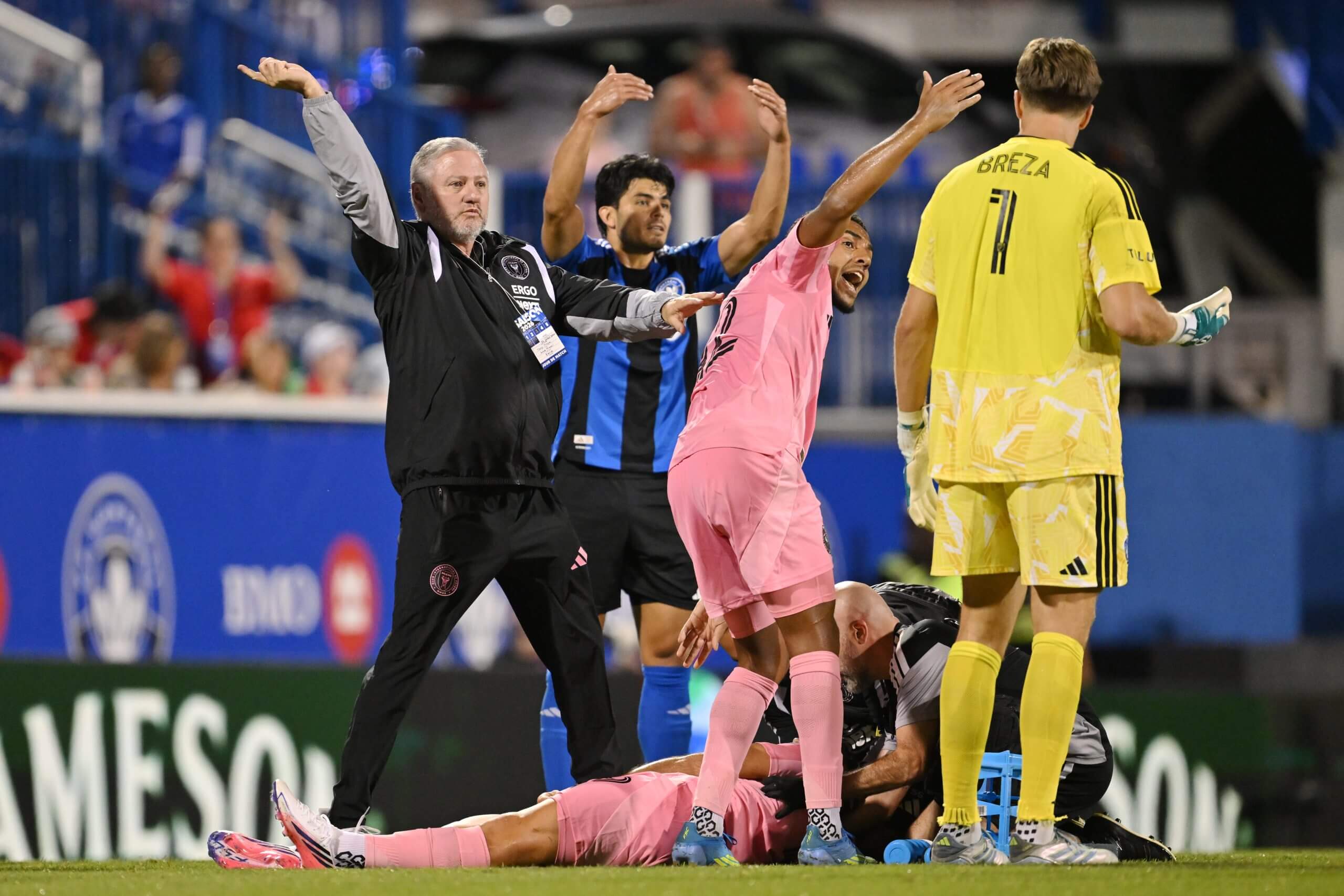 Image of Inter Miami and Montreal players waving for medical attention to come onto the pitch