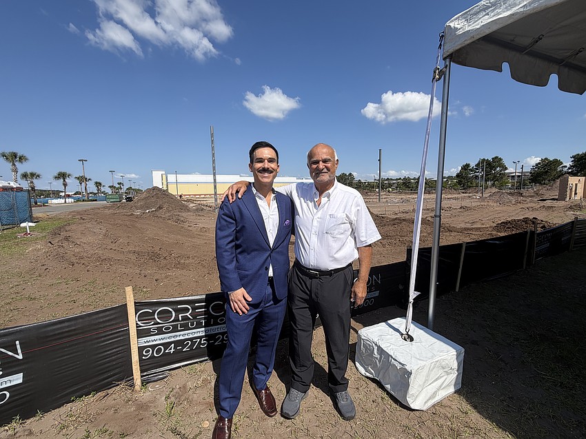 Sleiman Enterprises President Toney Sleiman, right, with his son, Hunter Sleiman, at the site where Sleiman Enterprises is developing a Harris Teeter grocery store in the Atlantic North shopping center. Sleiman Enterprises President Toney Sleiman, right, with his son, Hunter Sleiman, at the site where Sleiman Enterprises is developing a Harris Teeter grocery store in the Atlantic North shopping center.