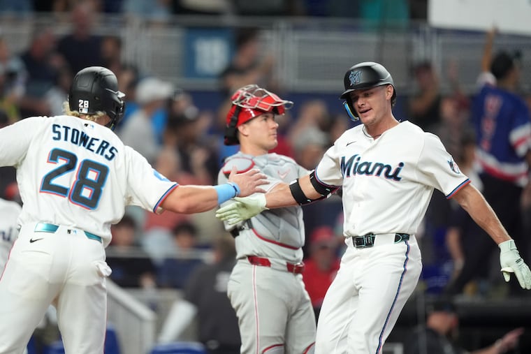 The Marlins' Griffin Conine (right) celebrates with Kyle Stowers after hitting a two-run home run to take an 8-6 lead on the Phillies in the eighth inning on Wednesday in Miami.