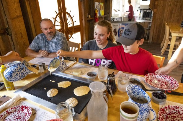 State park resident volunteers, from left, Tim Lugar, Kyrah Lewis and Jedidiah Lewis experience the reopened Old Sugar Mill Pancake House within De Leon Springs State Park on Monday, Oct. 17, 2022. A state parks annual pass makes for a great gift during the holidays. (Patrick Connolly/Orlando Sentinel)