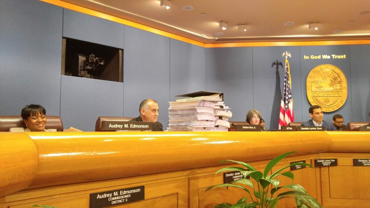 When the Miami-Dade SMART Plan was approved in April 2016, then-Commissioner Esteban “Steve” Bovo recalled past efforts to expand transit by bringing old transportation studies with him to the dais in the Miami-Dade Commission chambers. To his left is Miami-Dade’s future mayor, then-Commissioner Daniella Levine Cava.