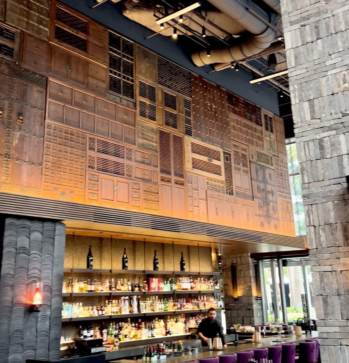 Hutong is decorated with a 70-foot-long wall of hand-carved Chinese wood paneling and doors.