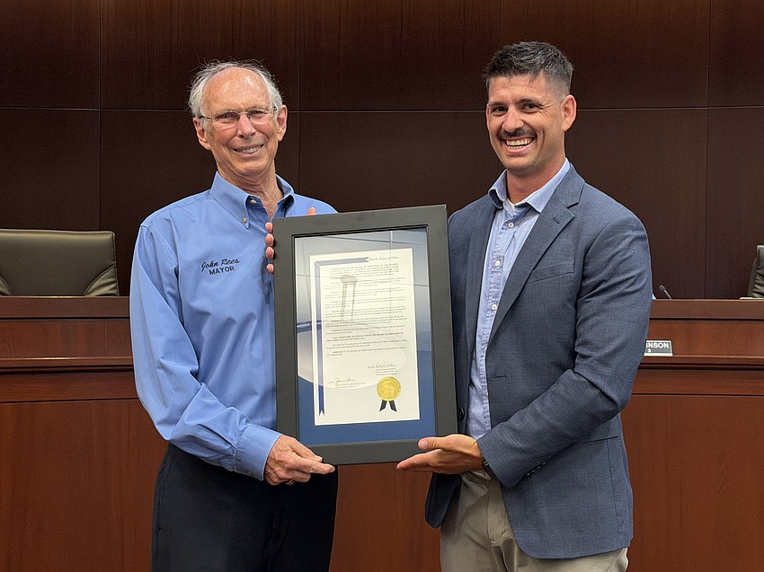 Mayor John Rees accepted the John Land Years of Service Award from Tyler Denehand with the Florida League of Cities.