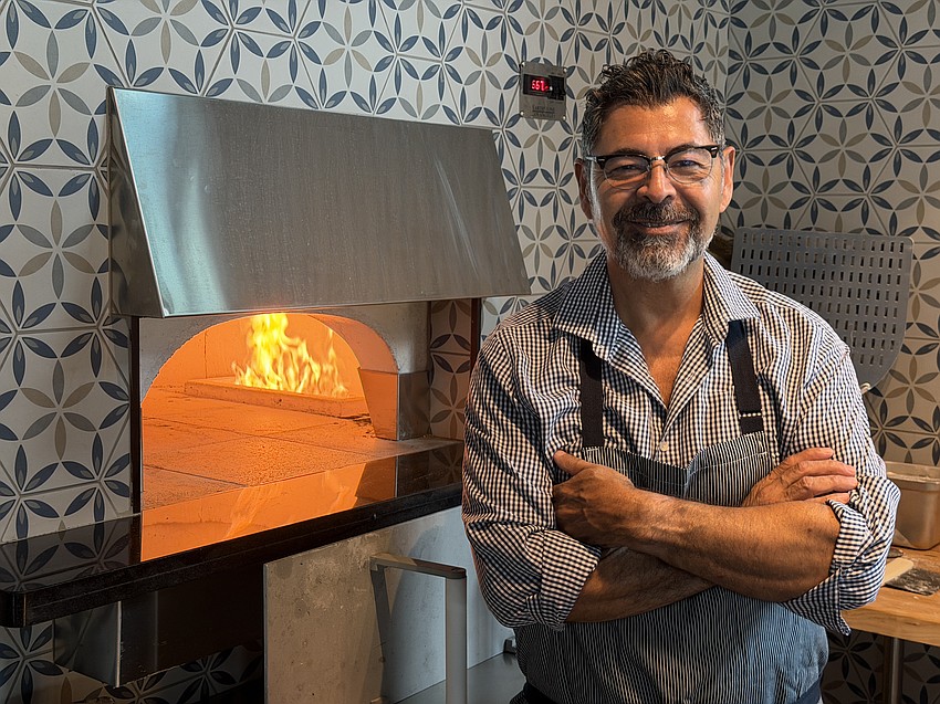 Eddy Escriba, operations partner at Alder & Oak and Oaxaca Club, in front of the new pizza oven in the main dining area at Alder & Oak at 131 First Ave. N.
