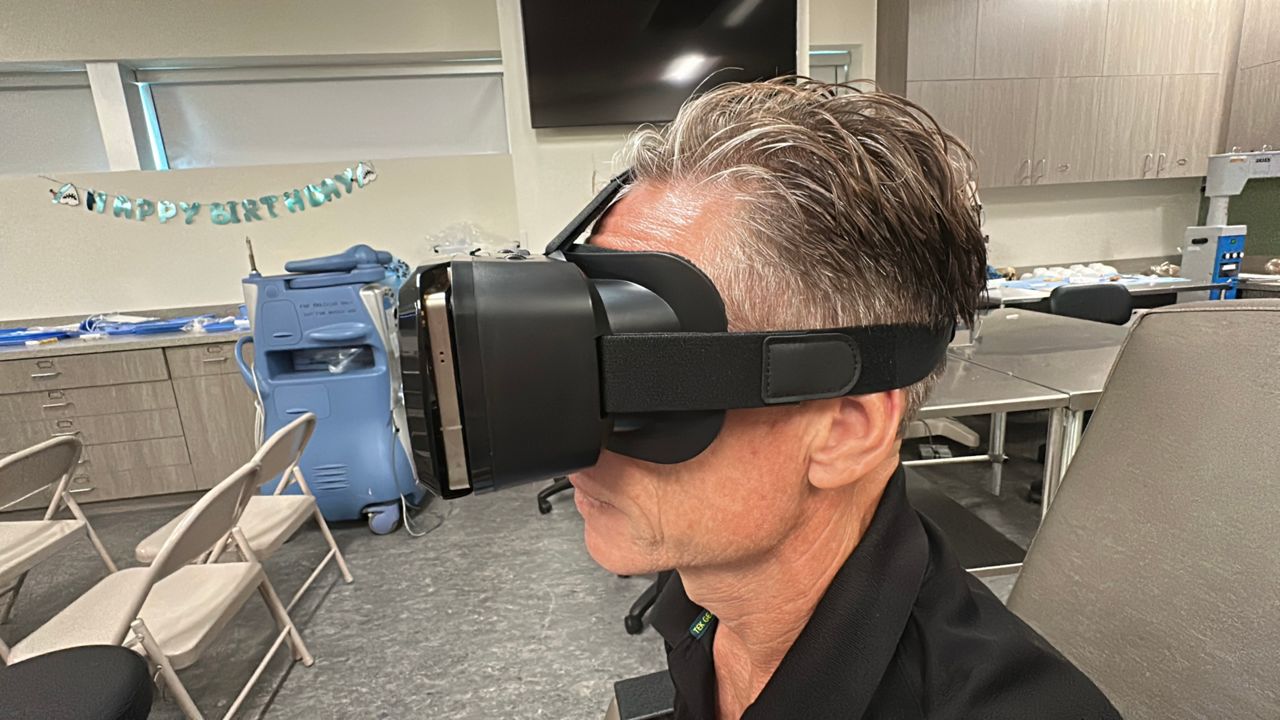 Jeffrey Reuter showcasing how the glaucoma screening tool works. (Spectrum News)