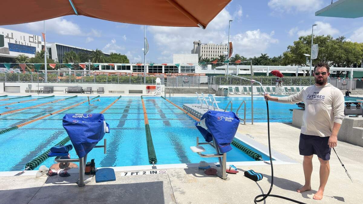 Hurricane Aquatics coach Andrew Pittman tries to cool down heated masters swimmers during practice on Monday, July 20, 2026, as a heat advisory put feels-like temperatures in the triple digits and the pool water temperature hovered in the mid-80s at the University of Miami.