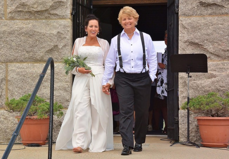 A lesbian couple walking out of Bride Pride