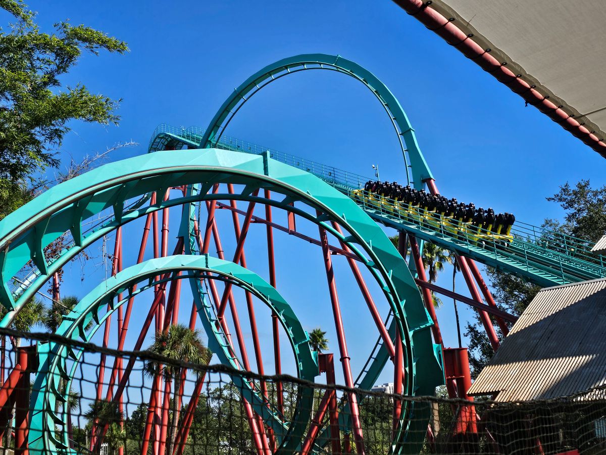 A full yellow coaster train climbing the massive lifthill of Kumba under a bright blue sky at Busch Gardens before Kumba closing on August 2.