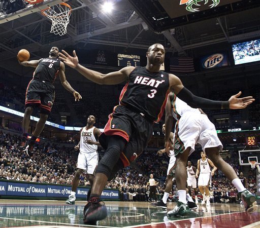 Miami Heat''s Dwyane Wade (3) reacts as teammate LeBron James (6) goes up for a dunk during the first half of an NBA basketball game against the Milwaukee Bucks Monday, Dec. 6, 2010, in Milwaukee. (AP Photo/Morry Gash)