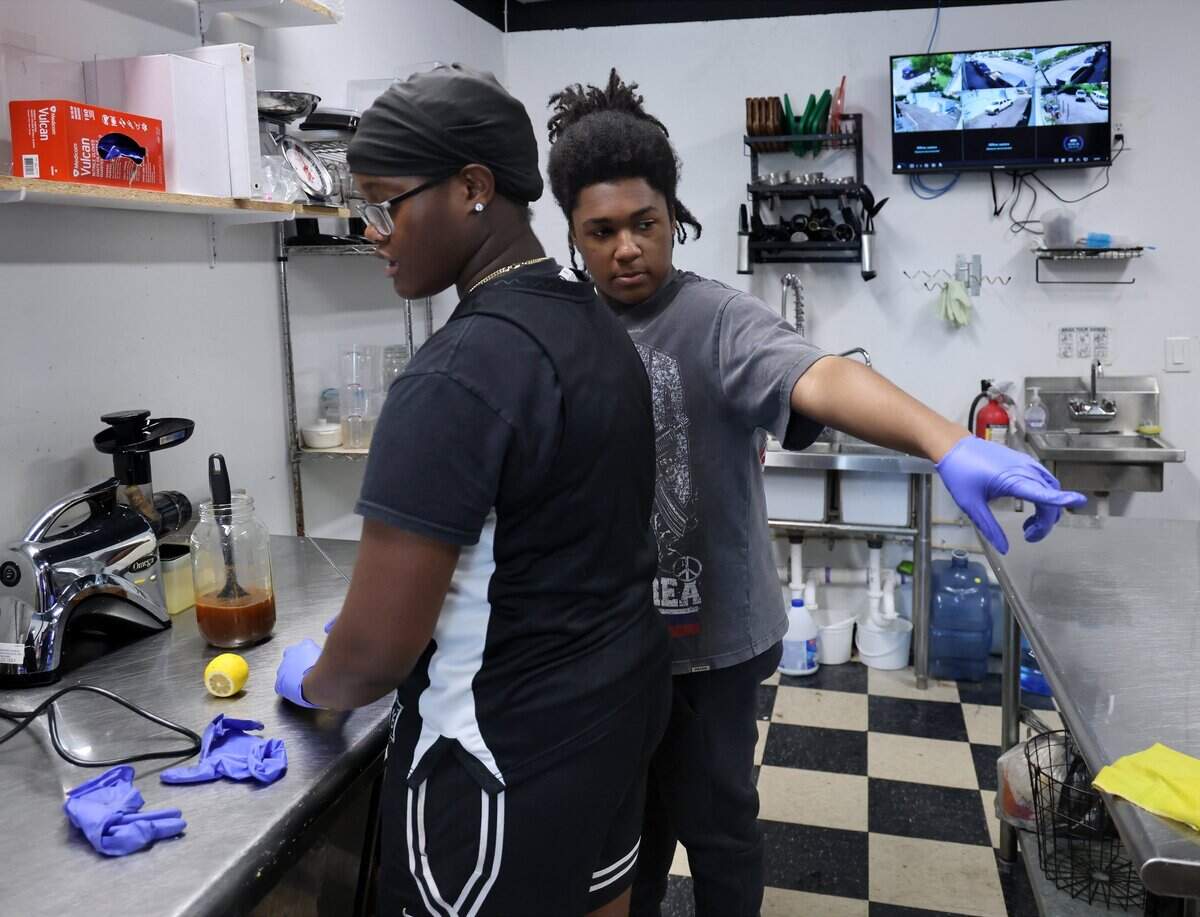 JuiceDefined interns Imani White, 17, left, and Darin Green, 17, right, help out in the Opa-locka kitchen on Thursday, July 30, 2026.