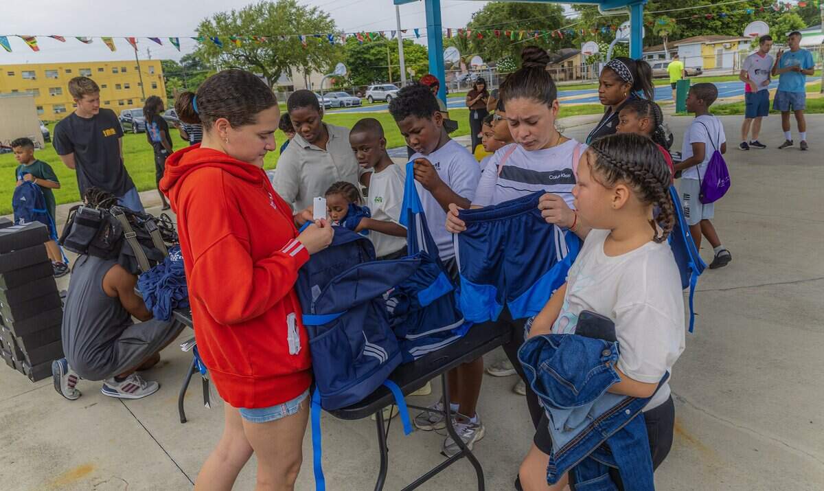 Rose Tirado, with Miami Scores, hands out back packs and gear to students from different Miami Dade schools selected to serve as player escorts during the 2026 FIFA World Cup, quarter-final game between England and Norway as Miami Scores program was selected to be part of the FIFA World Cup 26 Player Escort Program, on Saturday July 11, 2026.