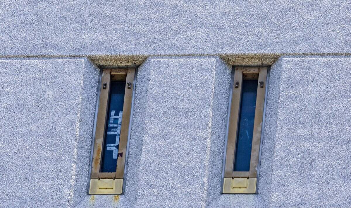 View of a “Help” sign posted in a window of the Federal Detention Center (FDC) in Downtown Miami as family members of Cuban migrants detained last the center held a press conference, to ask for them to be release, on Wednesday July 15, 2026.