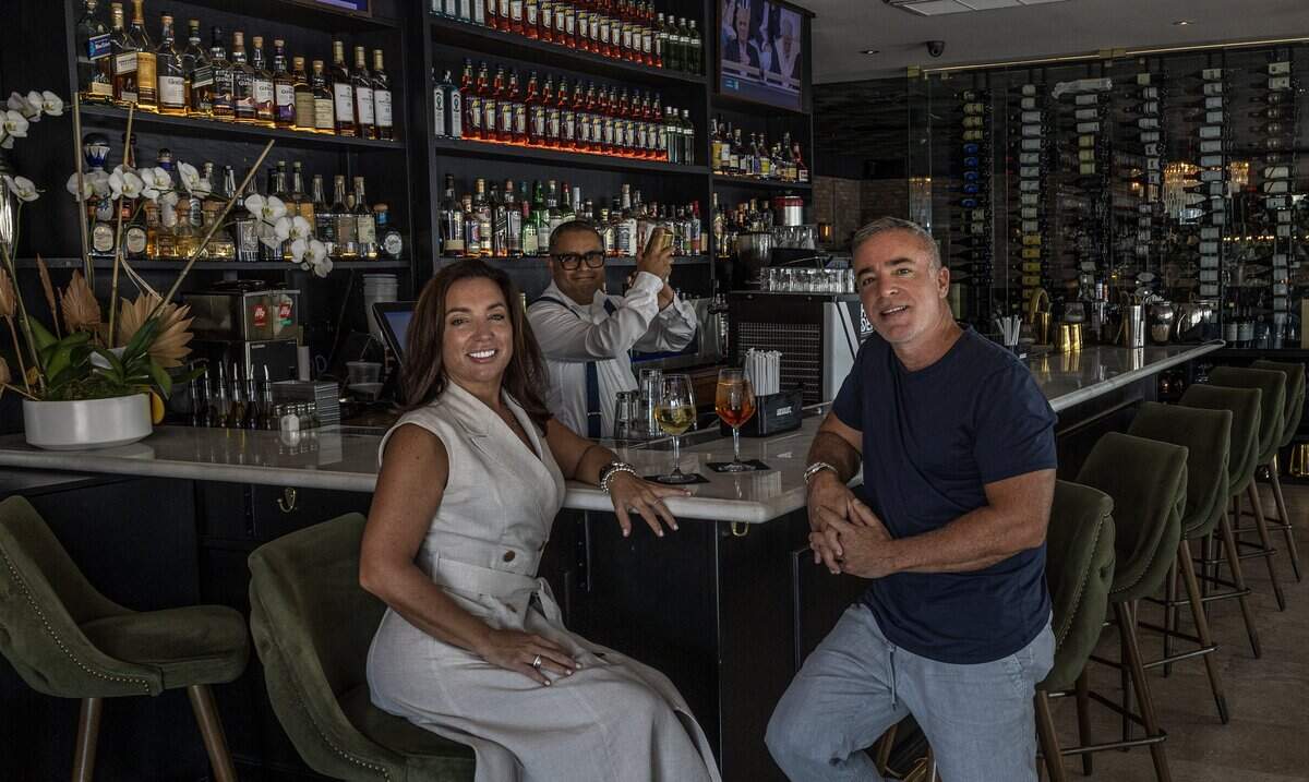 Bartender Christian Perez prepares drinks for owners and founders Elizabeth and George Iglesias, at the bar of George's, their Italian restaurant celebrating 25 years in North Beach, on Wednesday, August 20, 2025.