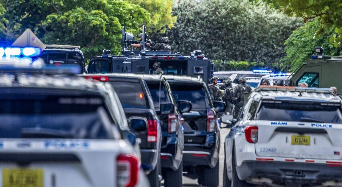 Officers with the police special response team are seen near Northwest 26th Street and 16th Avenue as law enforcement responded to a shooting in Allapattah on Thursday morning, Oct. 9, 2025. Authorities investigated the area between Northwest 14th and 15th avenues on 26th Street. Two Miami police officers were shot, and an armed man was barricaded inside a house.