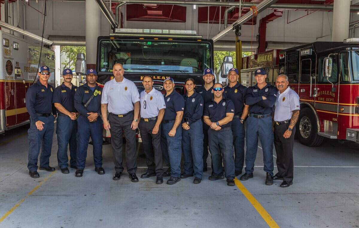 Hialeah Fire Chief Humfredo Perez, fourth from left, with firefighters as he leads a tour at the Hialeah Fire Station No.1, located at 93 E 5th St.