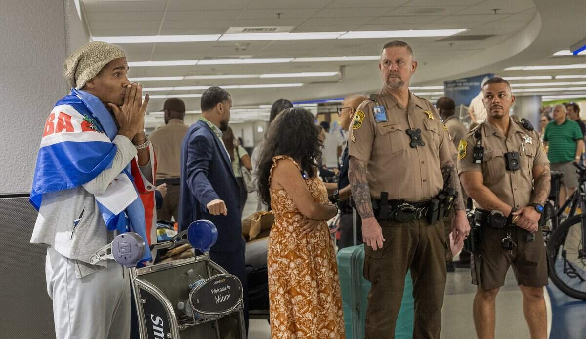 Cuban dissident artist Luis Manuel Otero Alcántara reacts as he arrives at the airport Saturday.