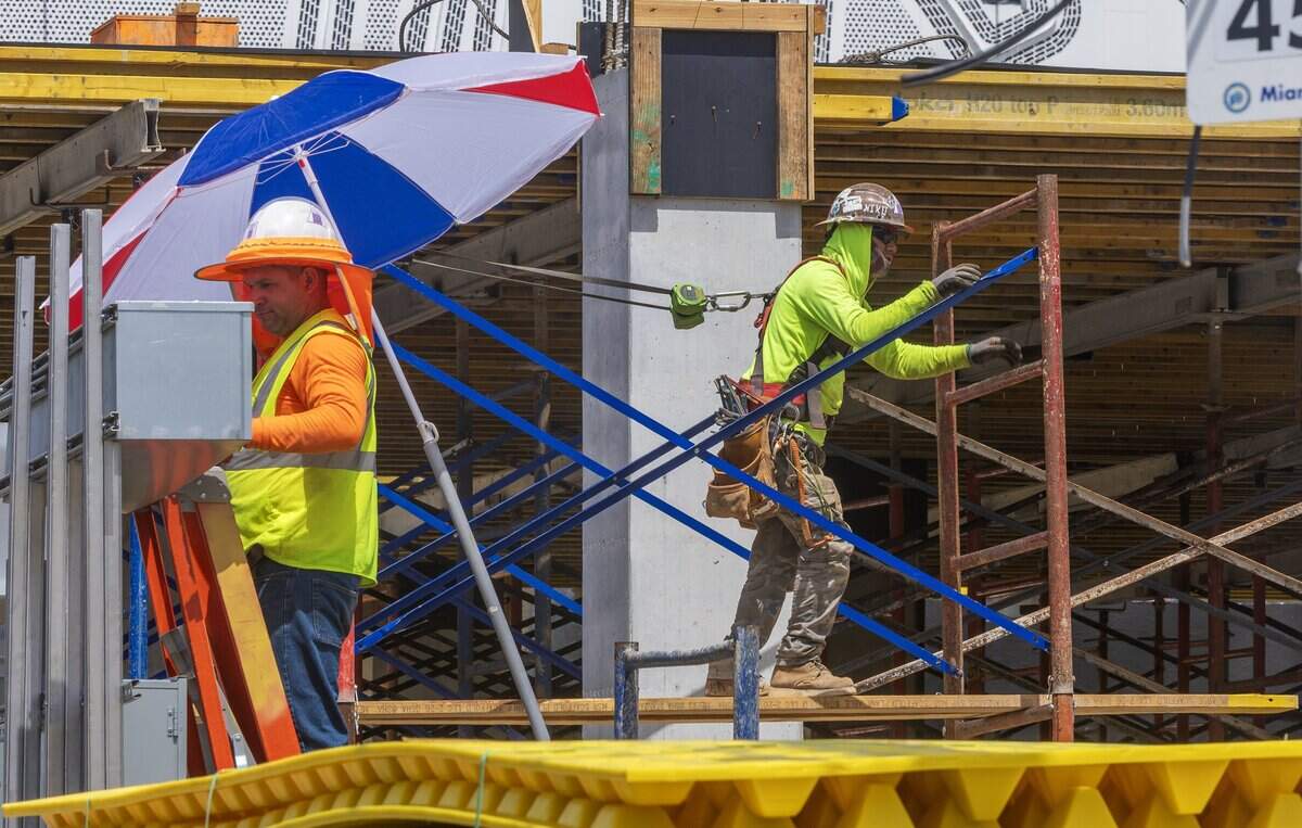 A construction worker takes cover under an umbrella while working on Wynwood in Miami, as a heat advisory is in effect for most of South Florida, on Wednesday, July 08, 2026.