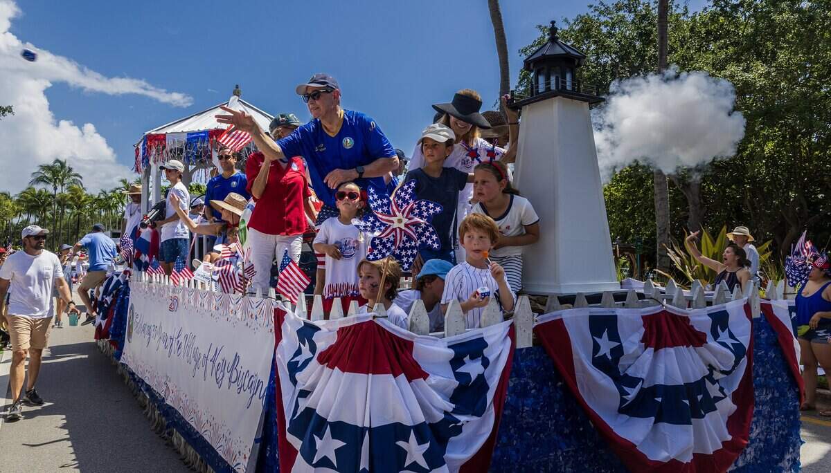 Mayor Joe I. Rasco greets residents from a float during the 67th annual Key Biscayne Fourth of July parade celebrating the America's 250th and the 35th anniversary of the Village's birth as its own municipality, on Saturday, July 04, 2026.