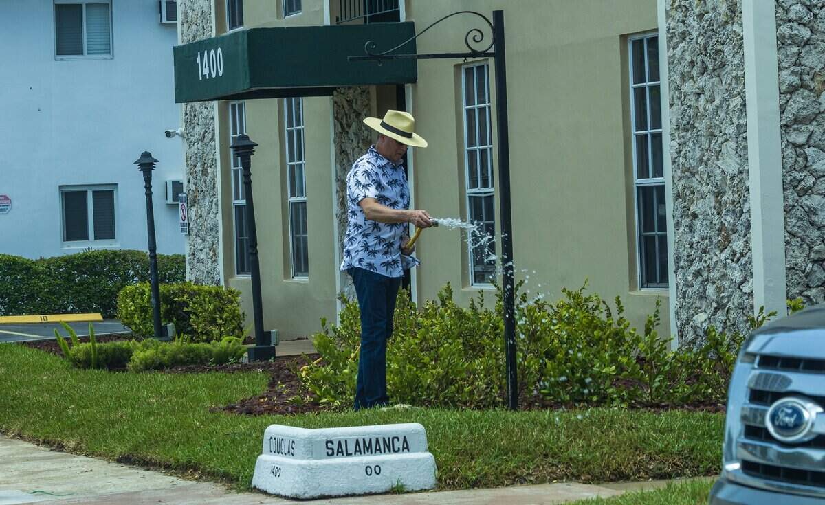 A man waters the grass and plants in Coral Gables as a heat advisory is in effect for most of South Florida, on Wednesday, July 08, 2026.