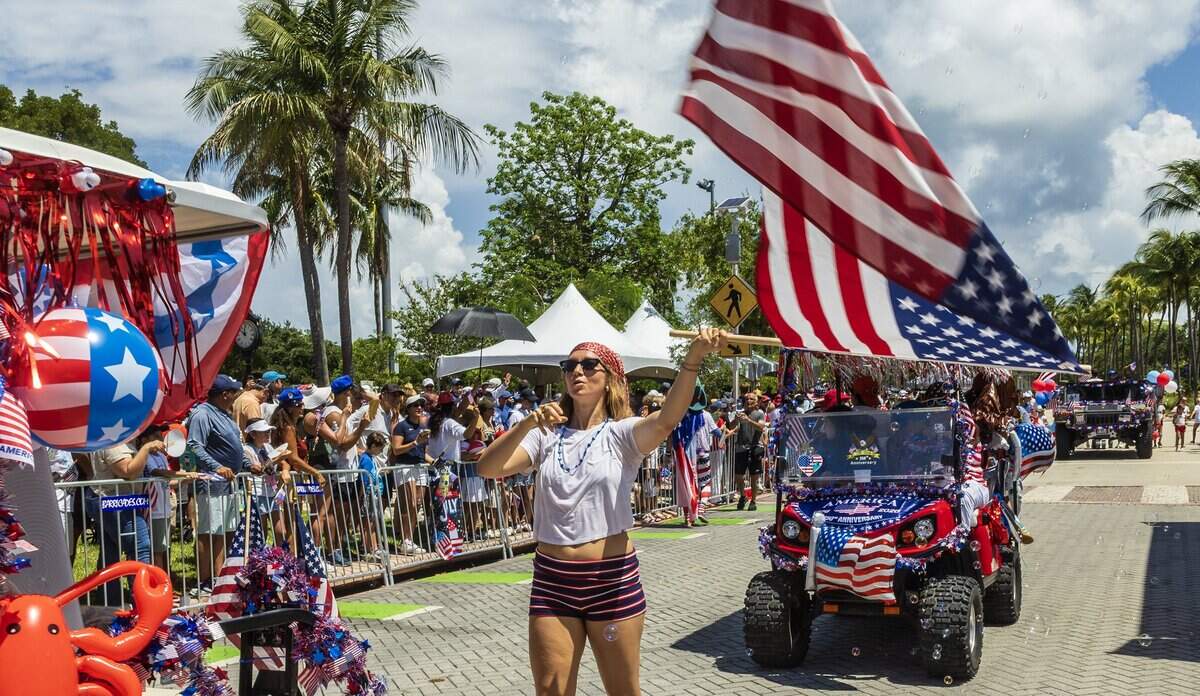Isabella Uribe waved an American flag as shemarched, during the 67th annual Key Biscayne Fourth of July parade celebrating the America's 250th and the 35th anniversary of the Village's birth as its own municipality, on Saturday, July 04, 2026.