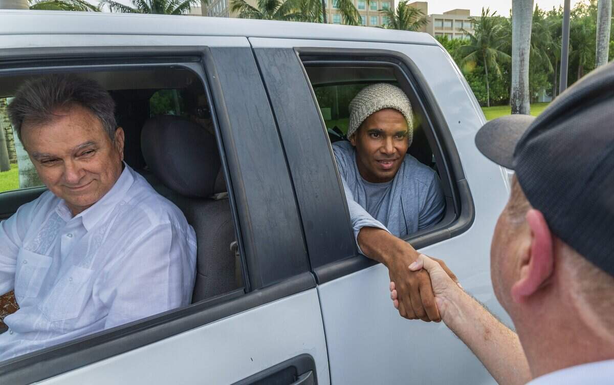 Ramon Saúl Sanchez, president of Movimiento Democracia, drives Cuban dissident artist Luis Manuel Otero Alcántara to Our Lady of Charity National Shrine on Saturday.