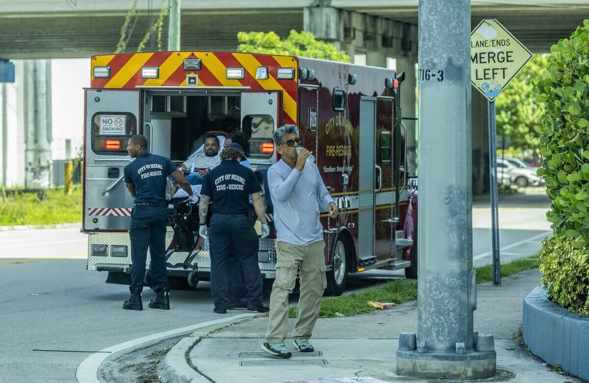 A man hydrates as the Fire Rescue take a man into a Fire Rescue truck in Wynwood Miami, as a heat advisory is in effect for most of South Florida, on Wednesday, July 08, 2026.