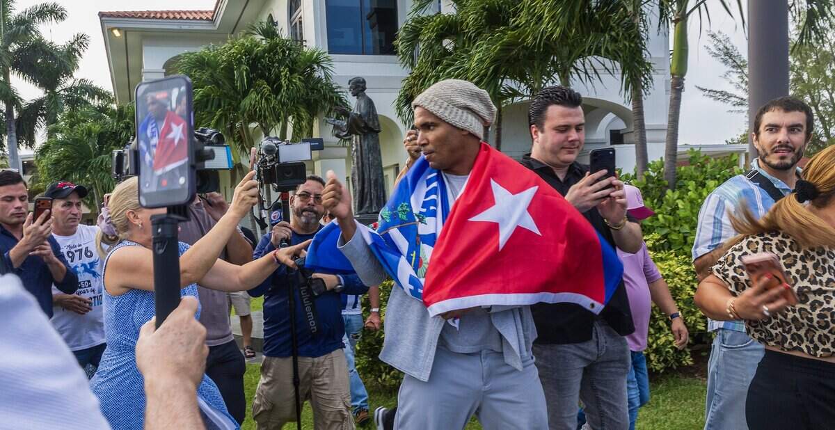 Cuban dissident artist Luis Manuel Otero Alcántara greets supporters at Our Lady of Charity National Shrine on Saturday after arriving from Cuba.