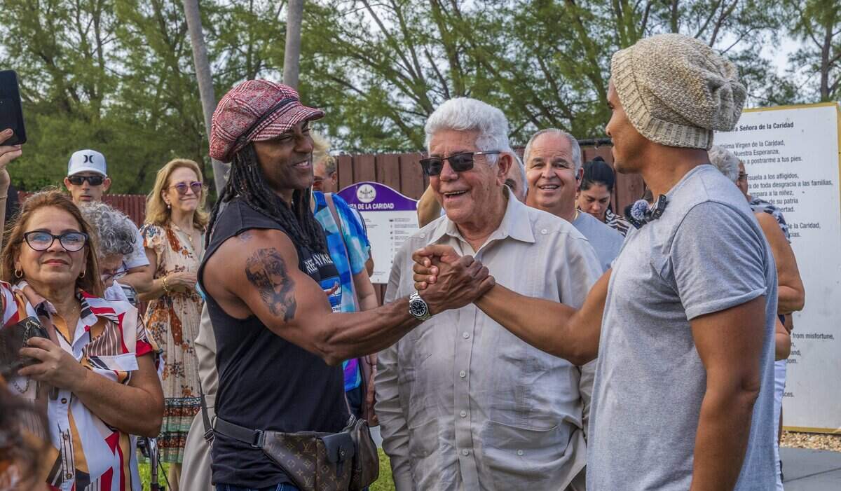 Artist Yotuel (left) and former Cuban political prisoner Ángel de Fana (center) welcome Cuban dissident artist Luis Manuel Otero Alcántara  at Our Lady of Charity National Shrine.