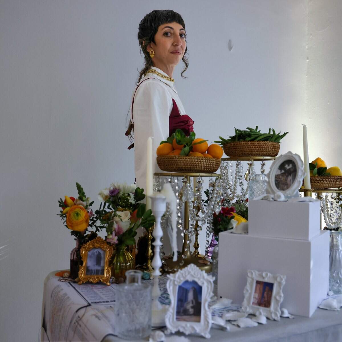 Artist and genealogist Ariana Franco is one of the many young creatives participating in the “Turn of A Century art event hosted by friends - Sophia Corugedo, and Sofia Villalonga, hosted the Turn of a Century event at the 100-year-old home, which is slated for demolition after being sold to a developer on Monday, July 13, 2026, in Miami, Fla. Franco explored the past history of the home in her installation. The gathering features artists, performers and dancers saying farewell to the house before the owners move out by July 15.