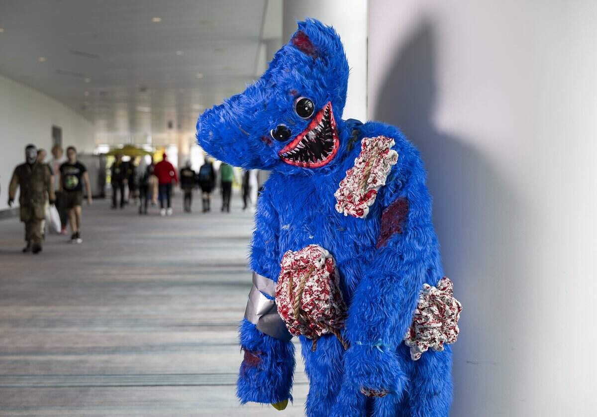 Timothy Alonso cosplays as Huggy Wuggy from Poppy Play Time during Florida Supercon 2026 at the Miami Beach Convention Center on Friday, July 10, 2026, in Miami Beach, Fla.