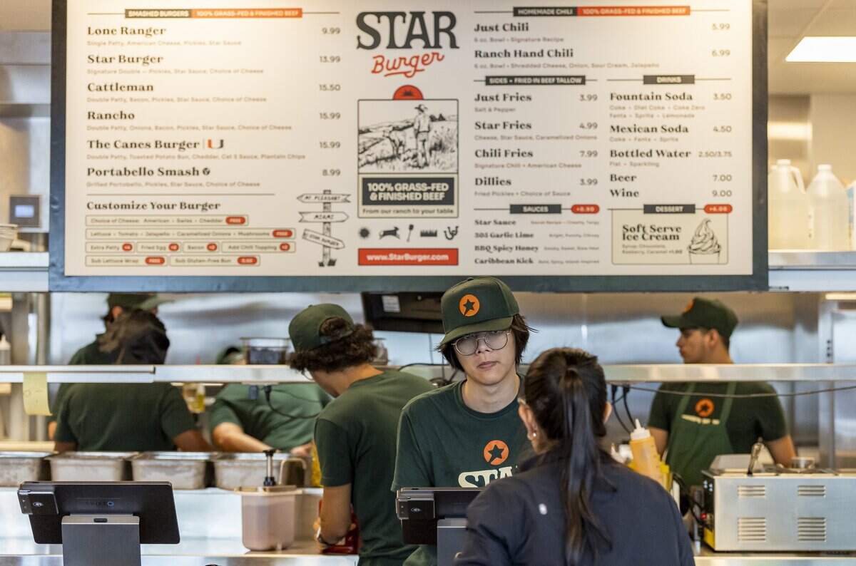 Star Burger cashier Huy Pham takes an order at the restaurant on Tuesday, July 28, 2026 in Miami, Fla.