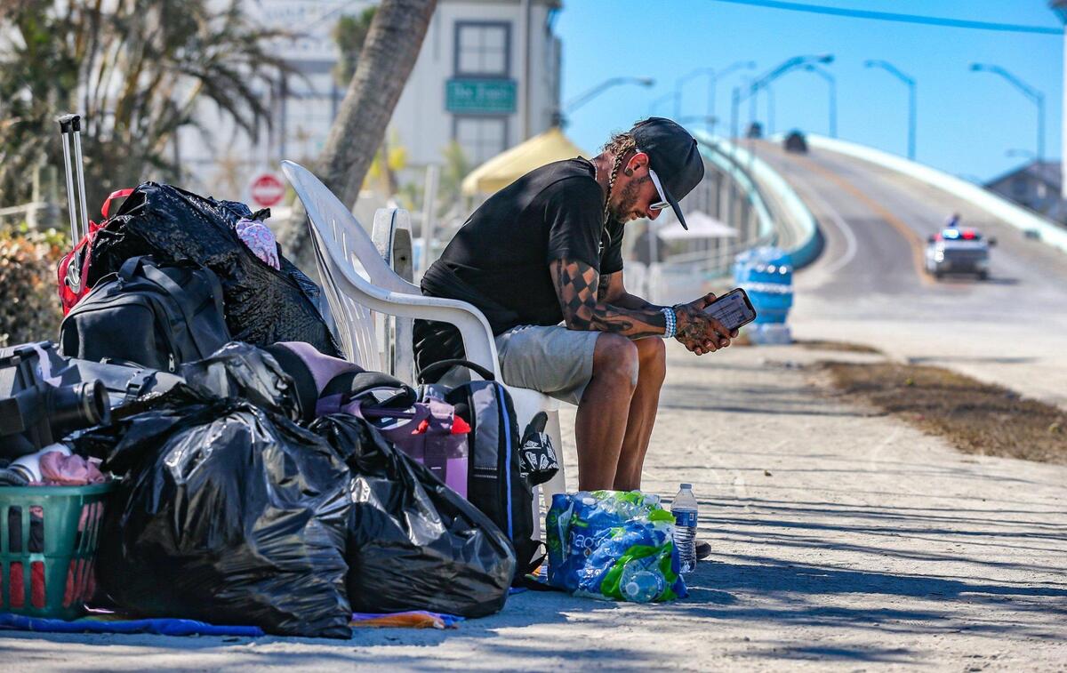 Evacuee Michael Gowen waits for transportation after being evacuated to San Marco Island from Fort Myers Beach on Monday, Oct. 3, 2022, after Hurricane Ian hit the area.