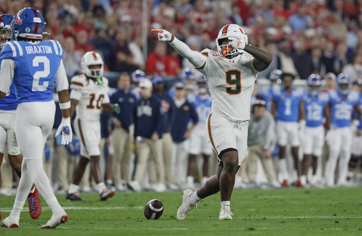 Miami Hurricanes tight end Elija Lofton (9) signals a first down against the Mississippi Rebels during the first half of a College Football Playoff semifinal in the Fiesta Bowl at State Farm Stadium on Thursday, January 8, 2026 in Glendale, Arizona.