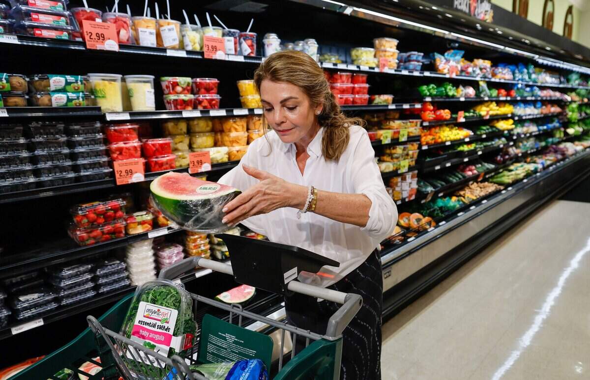 Customer Marcela Ash grocery shops while using Coupr, a smart cart screen used for personalized supermarket shopping. The device and app is installed on carts at Milam's Market in Pinecrest, Florida on Wednesday, July 8, 2026,
