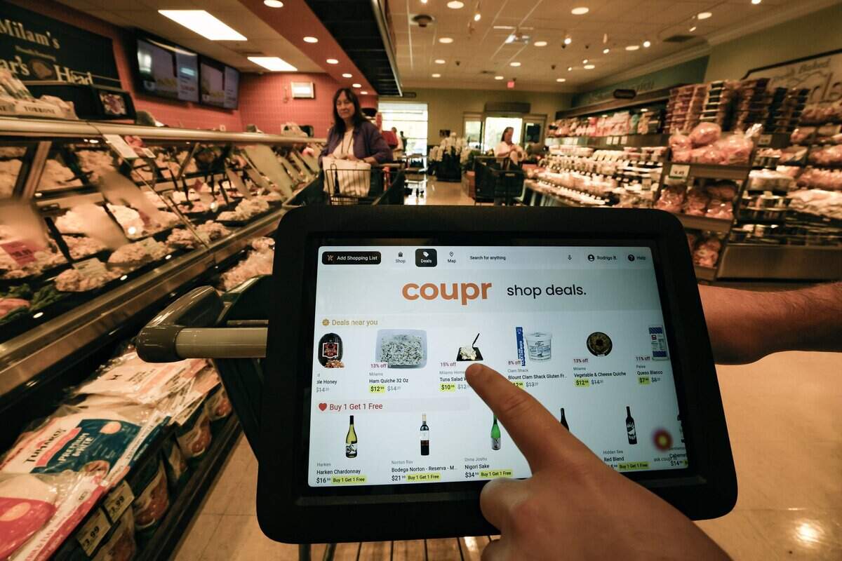 A smart cart screen displays shopping deals while using the Coupr app. The app personalizes supermarket shopping and is installed on carts at Milam's Market in Pinecrest, Florida on Wednesday, July 8, 2026,