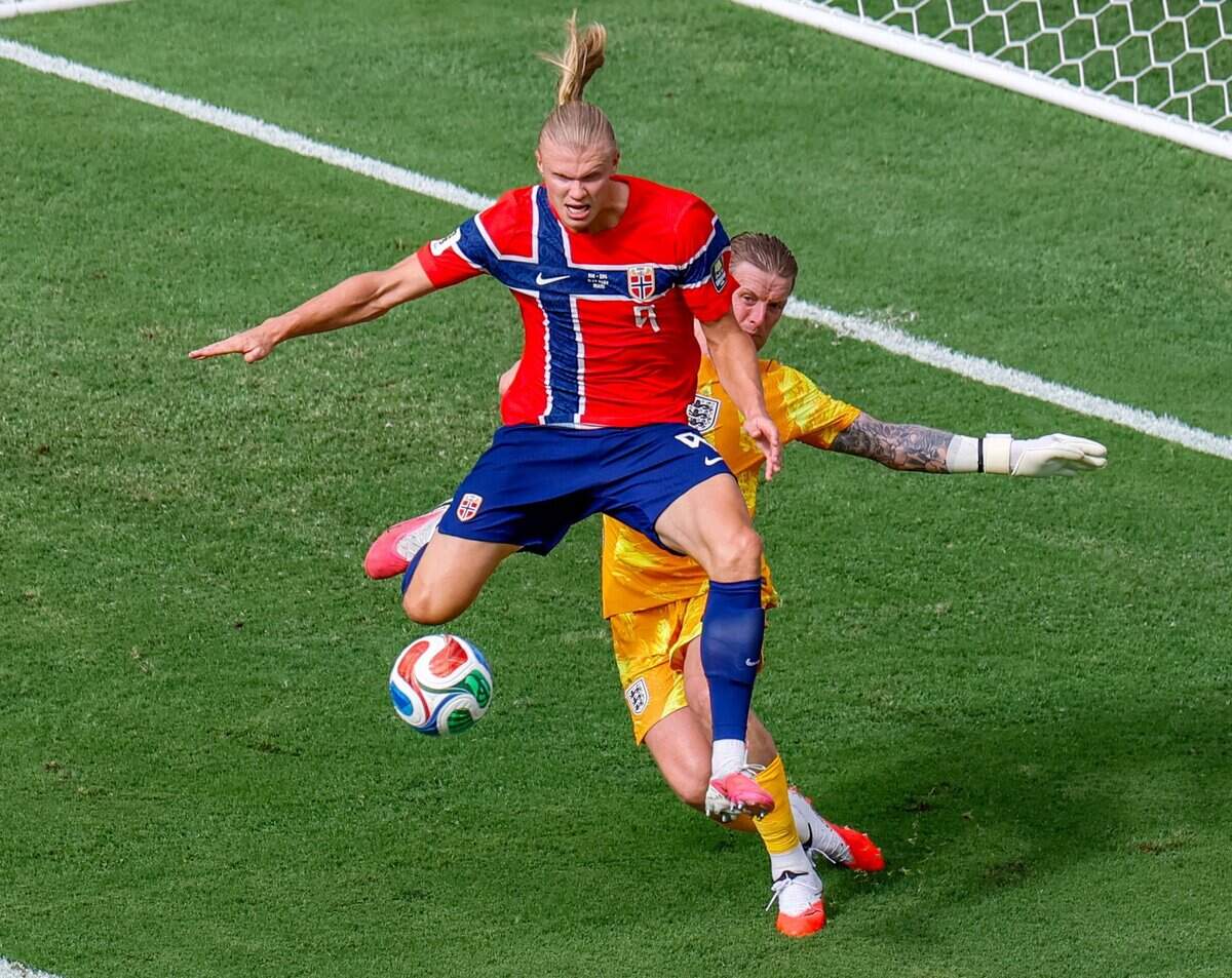 Norway forward Erling Haaland (9) battles England goalkeeper Jordan Pickford (1) at the goal in the first half of their FIFA World Cup 2026 Quarter Final soccer match at Hard Rock Stadium (Miami Stadium) on Saturday, July 11, 2026 in Miami Gardens, Fla.