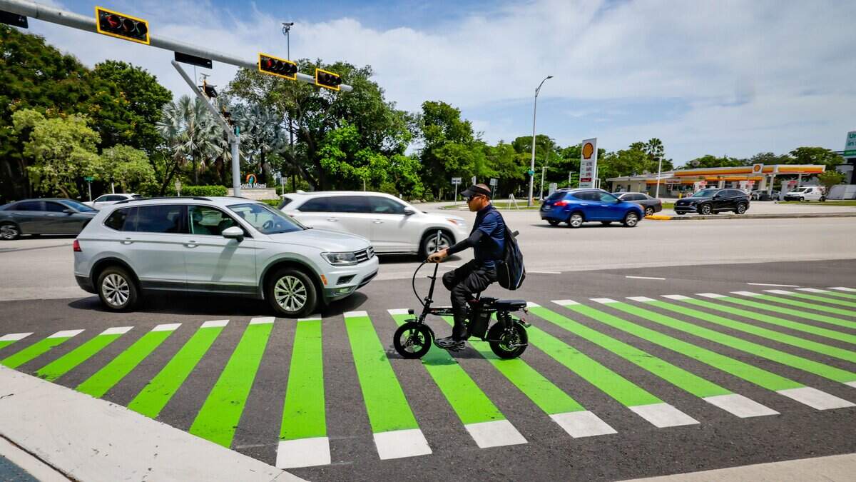 A motorized bike crosses the intersection at US1 and SW 88th Street in Segment 9 of The Underline on Tuesday, July 14, 2026 in Miami, Florida. The southernmost 7.36-mile phase extends from SW 65th Avenue to the Dadeland South Metrorail Station.